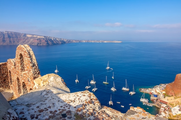 Griechenland. Santorini. Thira Insel. Ruinen in Oia und eine Draufsicht auf Segelkatamarane im Hafen