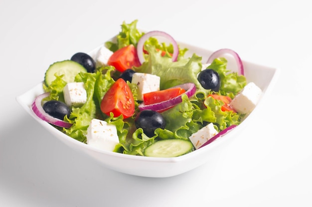 Griechischer Salat mit frischen Tomaten, Gurken, Oliven, Feta-Käse und roten Zwiebeln Gesundes und diätisches Lebensmittelkonzept
