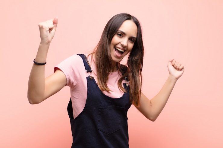 Foto gritando triunfante, luciendo emocionado, feliz y sorprendido ganador, celebrando