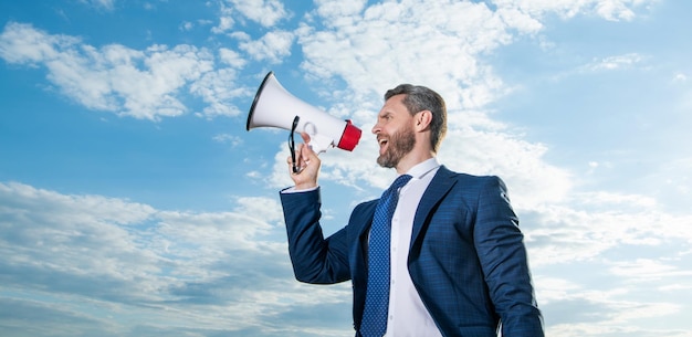 Grito do homem de negócios no megafone no fundo do céu