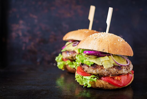 Großes Sandwich - Hamburgerburger mit Rindfleisch, Tomate, Käse und in Essig eingelegter Gurke.