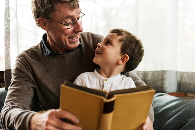 Großvater und Enkel, die zusammen ein Buch lesen