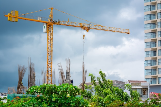 Grúa de construcción con trabajadores en el sitio de construcción.