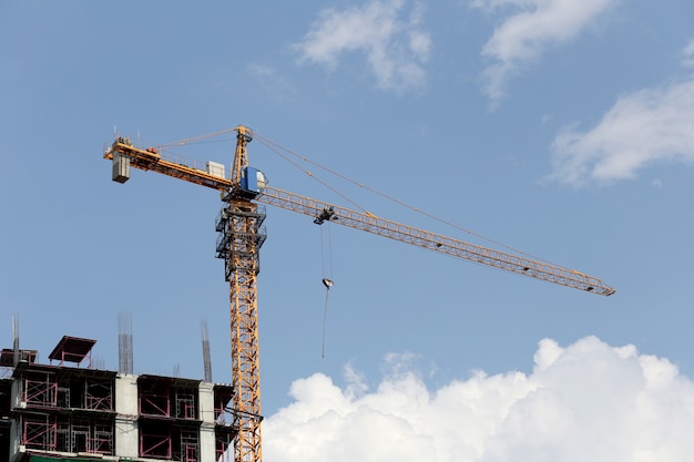 Grúa trabajando en un edificio en construcción en el día.