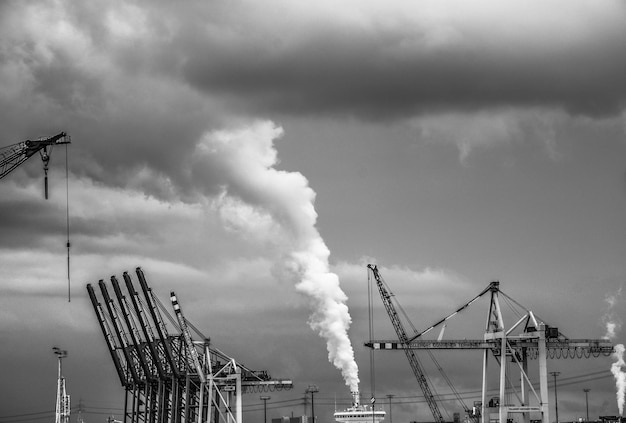 Grúas contra fábricas que emiten humo