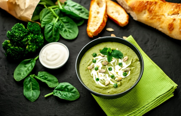 Grüne Sahnesuppe aus Spinat und Brokkoli. Beton- oder Schieferhintergrund. Das Konzept einer gesunden Ernährung und Ernährung.