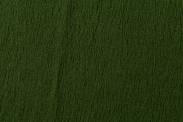 Grüne Tapete mit zerknitterter Textur Grüne grungy Papierstruktur schmerzte Wandhintergrund mit Muster