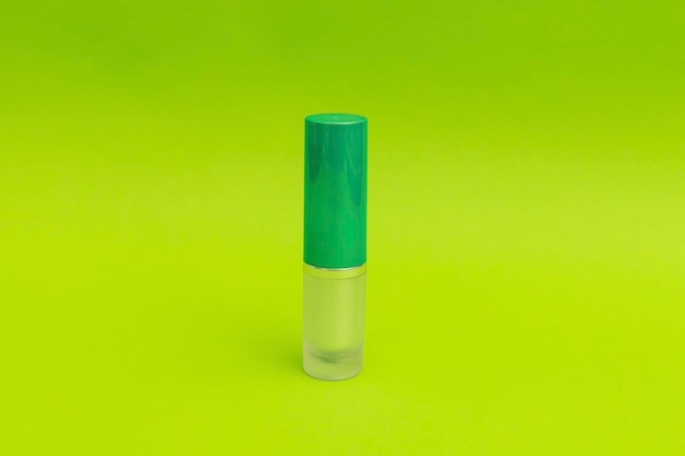 Grüner Lippenstift auf grünem Hintergrundmonochrom