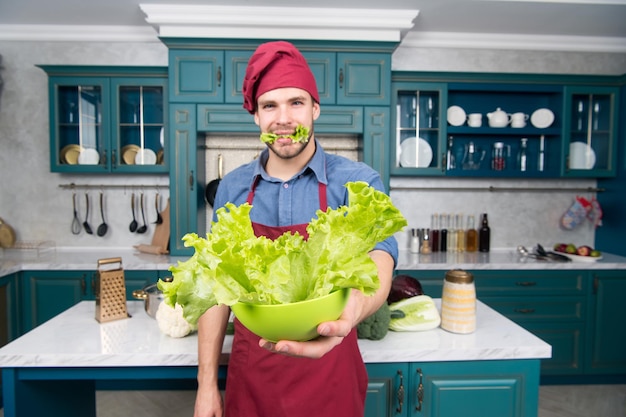 Grüner Salat enthält viele Nährstoffe. Koch kocht grünen Salat. ergänzen Sie Ihre Ernährung. gesundheitliche Vorteile von Salat. selektiver Fokus. Blattgemüse gute Wahl für eine gesunde Ernährung. Bauen Sie den perfekten Salat.