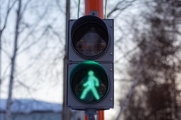 Grünes Licht an einer Fußgängerampel. Sicheres Überqueren der Straße durch Fußgänger.