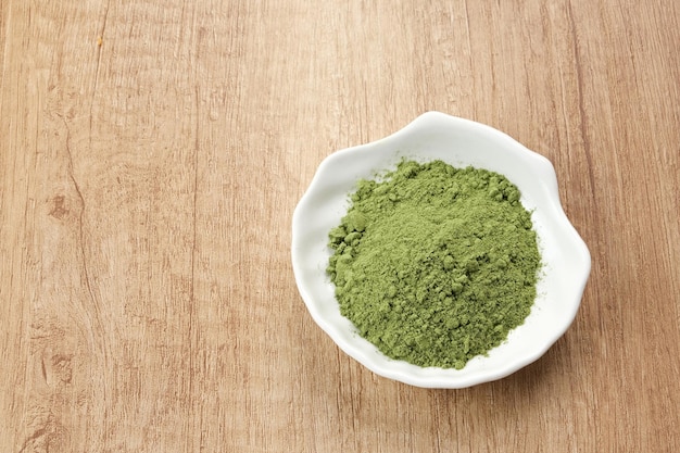 Grünes Matcha-Pulver in weißer Schüssel Lebensmittelzutat