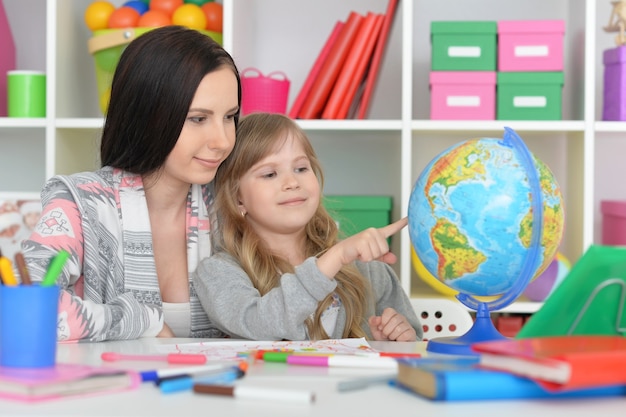 Grundschulklasse mit schönem Lehrer und kleinem Mädchen