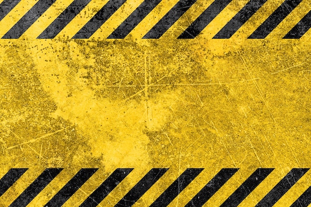 Grunge-gelbe und schwarze diagonale Streifen Industrieller Warn-Hintergrund