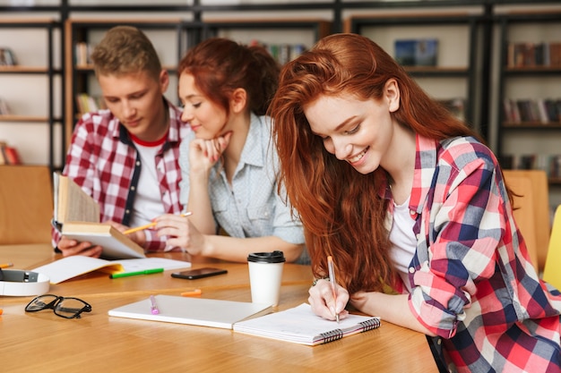 Grupo de adolescentes felices haciendo los deberes