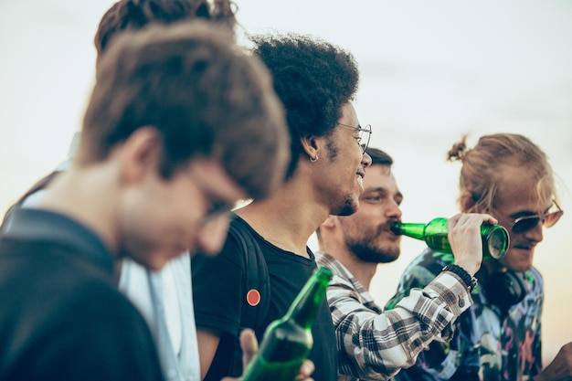 Grupo de amigos celebrando, descansando, divirtiéndose y festejando en verano