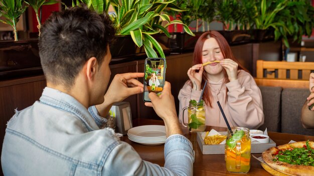 Un grupo de amigos descansando en un pub. Comer, beber, comida en la mesa. Amistad