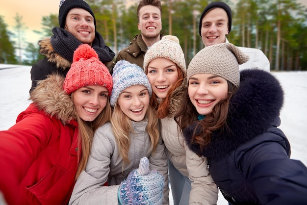 grupo de amigos tomando selfies al aire libre en invierno