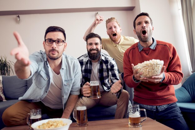 Foto grupo de amigos viendo partido de tv