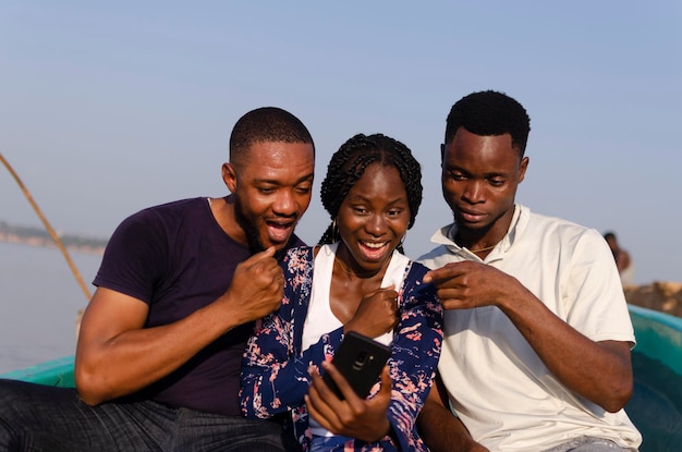 Grupo de amigos africanos empolgados com o que viram no celular