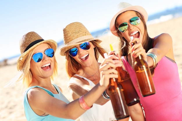 grupo de amigos bebendo cerveja na praia