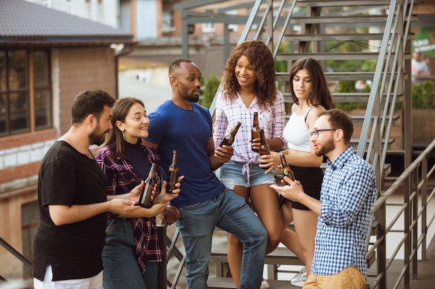 Grupo de amigos felizes, tendo a festa da cerveja em dia de verão.