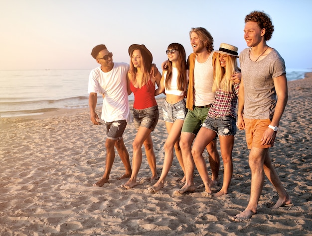 Grupo de amigos se divertindo na praia ensolarada