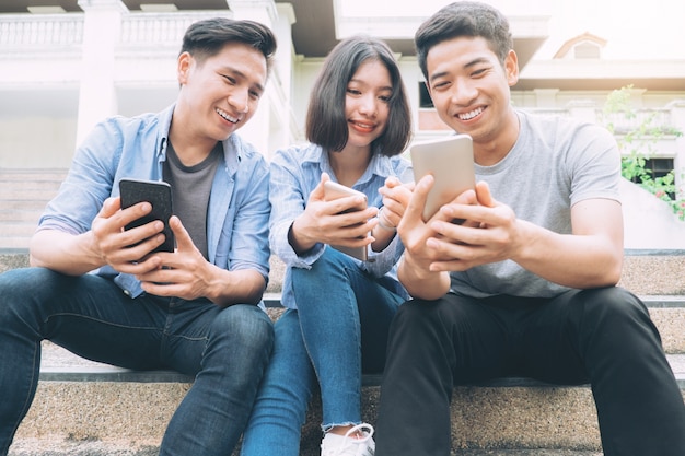 Grupo de jovens adolescentes usando telefones celulares.