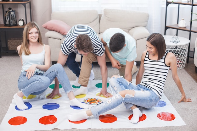 Grupo de jovens jogando dentro de casa. amigos se divertindo. jogos ativos.