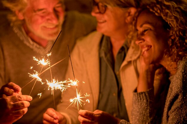 Foto grupo de pessoas e família celebrando alguma festa ou ano novo juntos no terraço da casa