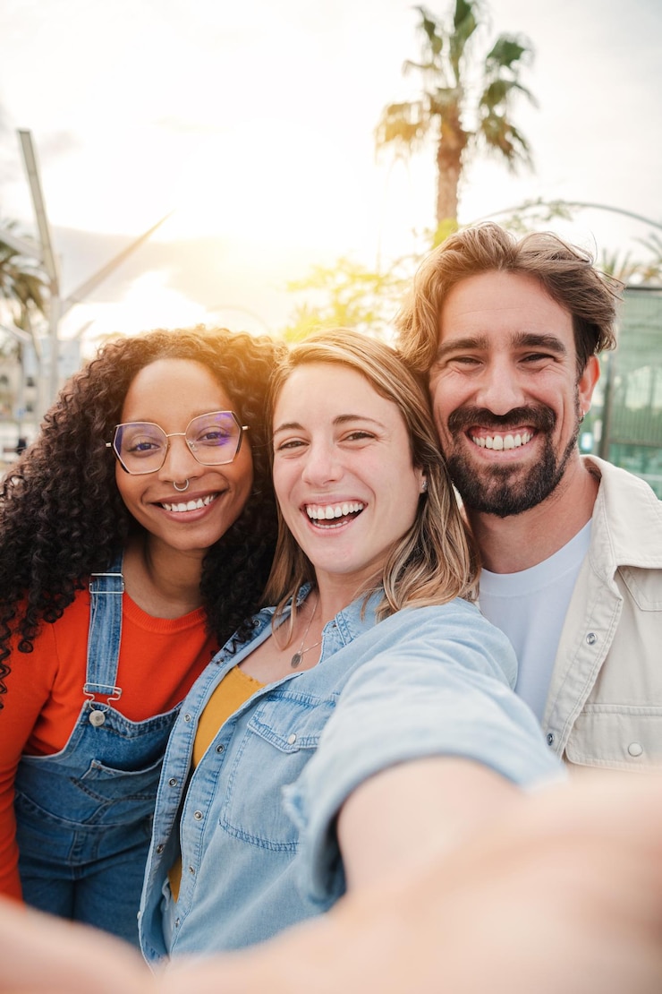 Foto grupo de retratos verticais de amigos jovens adultos sorrindo, tirando um retrato de selfie e se divertindo