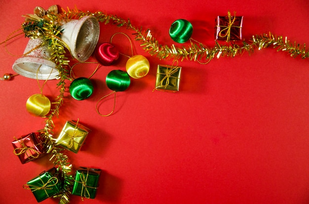 Foto grupo de sino, bola e presente de natal em fundo vermelho na vista superior