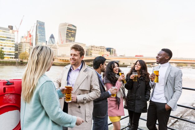 Grupo empresarial bebiendo cerveza después del trabajo en Londres.