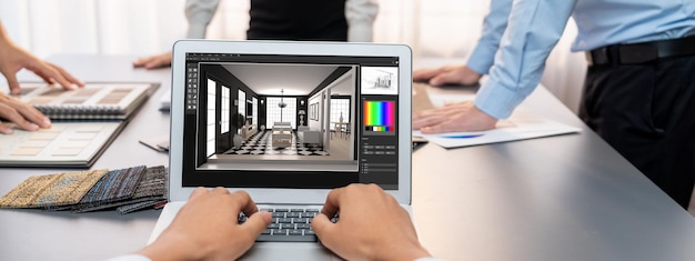 Grupo de equipo de diseño de arquitectos de interiores en la mesa eligiendo varias muestras de paneles de estado de ánimo con software de arquitectura en la pantalla del portátil Renovación moderna y concepto de selección de materiales interiores Insight