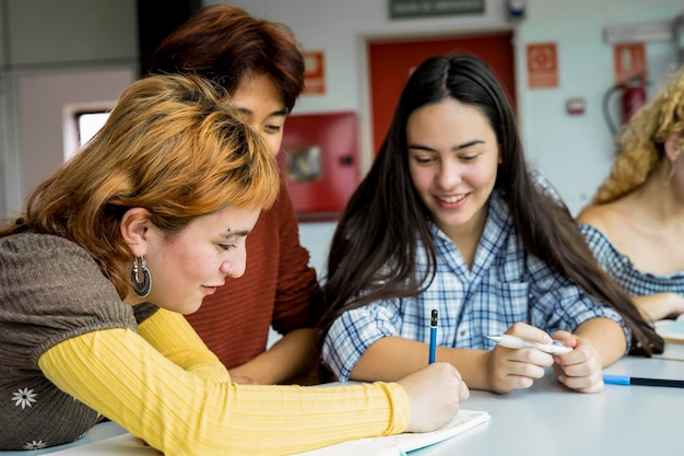 Grupo de estudiantes universitarios que estudian juntos en una biblioteca