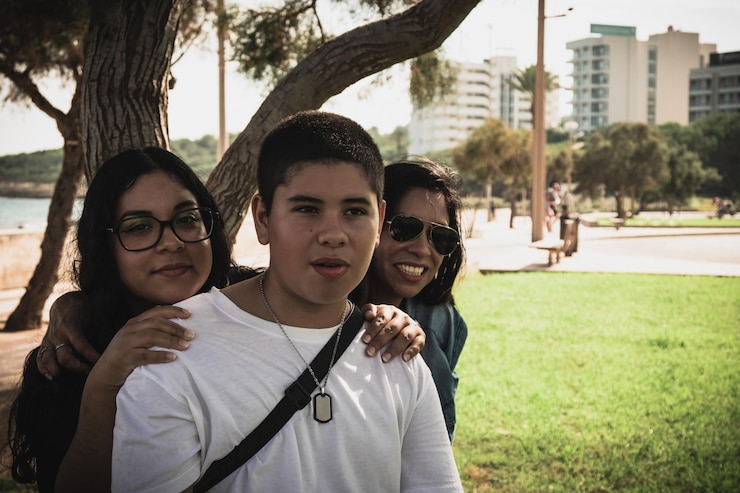 Foto un grupo feliz de jóvenes latinos sonriendo a la cámara al aire libre.