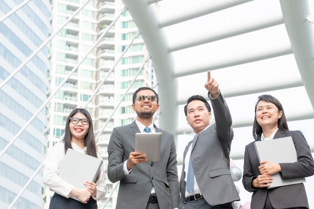 Grupo de hombres y mujeres de negocios trabajan juntos fuera de la oficina.