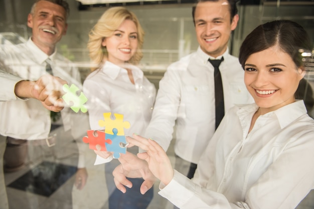 Foto grupo de hombres de negocios que ensamblan rompecabezas.