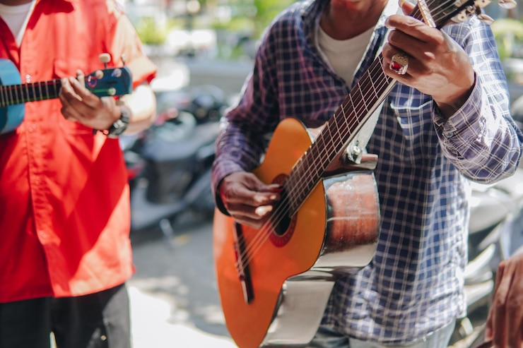 Foto grupo de hombres que tocan el instrumento musical de la guitarra para entretener a la gente