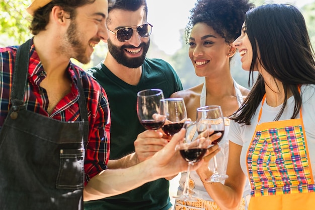 Un grupo de jóvenes amigos brinda con vino tinto durante la vendimia