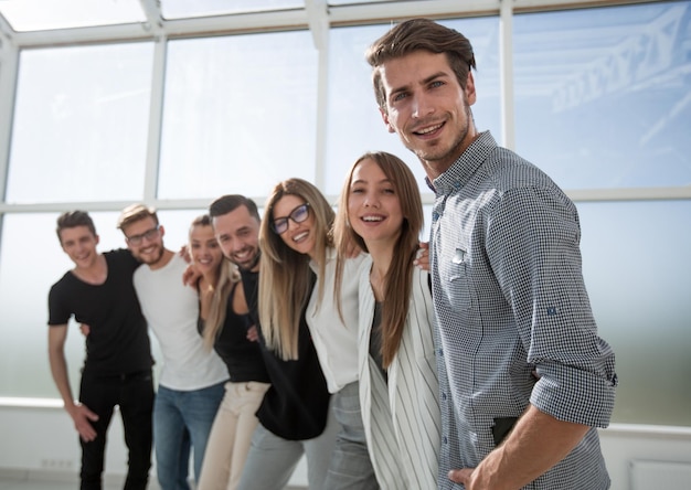 Foto grupo de jóvenes exitosos de pie en la oficina