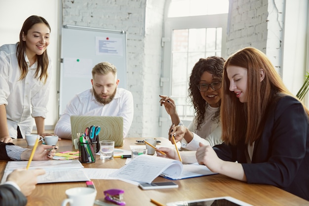 Grupo de jóvenes profesionales de negocios que tienen una reunión, oficina creativa