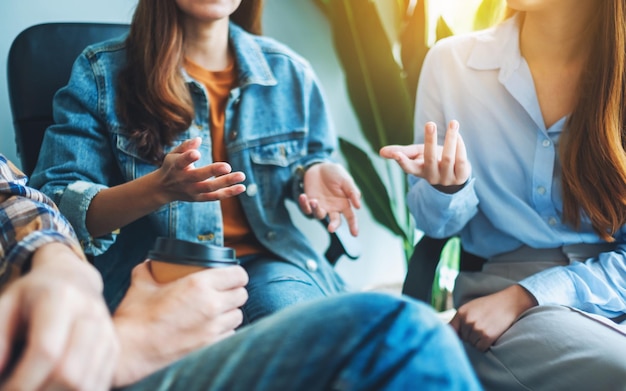 Un grupo de jóvenes sentados y hablando juntos.