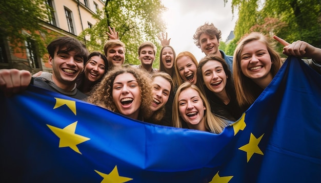 Foto un grupo de jóvenes se toman un selfie en el fondo ondea la bandera de la unión europea