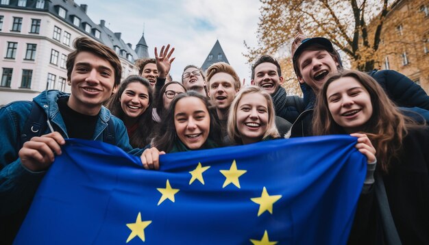 Foto un grupo de jóvenes se toman un selfie en el fondo ondea la bandera de la unión europea