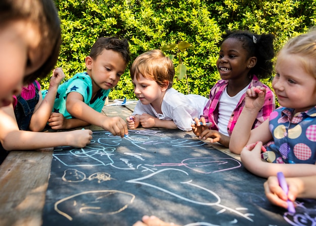 Grupo de kindergarten niños amigos dibujo clase de arte al aire libre