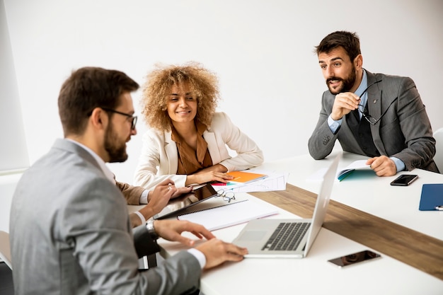 Grupo multiétnico de jovens empresários trabalhando juntos e preparando novo projeto em reunião no escritório