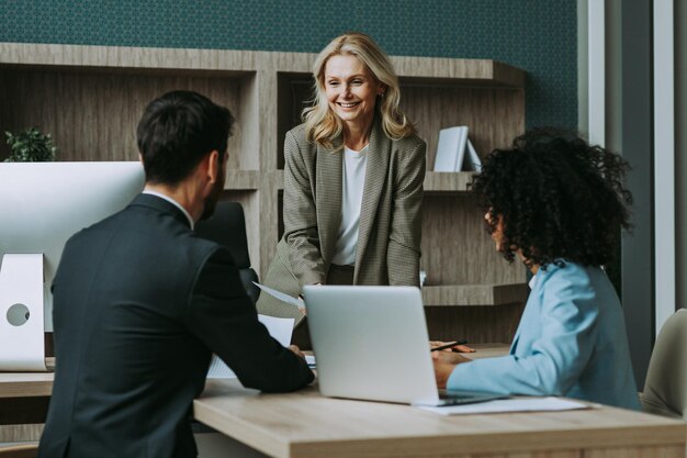 Grupo multirracial de empresários com vestido elegante sentado na mesa do computador no escritório