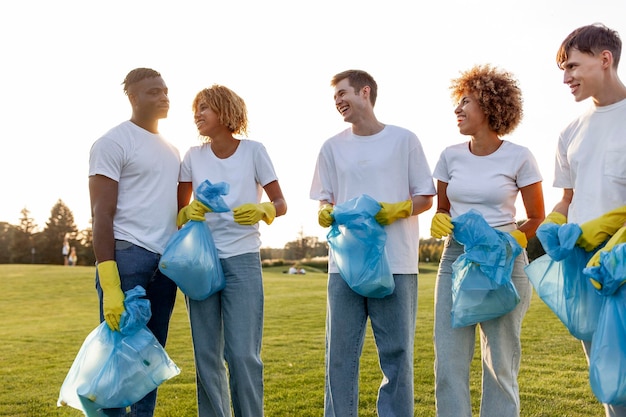 Foto grupo multirracial de personas voluntarios con guantes con bolsas de basura recogen basura y plástico