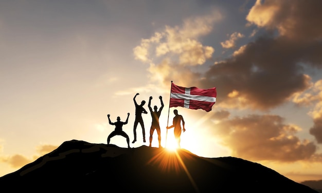 Un grupo de personas celebra en la cima de una montaña con la bandera de dinamarca d render