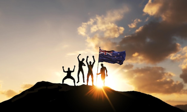 Un grupo de personas celebra en la cima de una montaña con la bandera de nueva zelanda d render